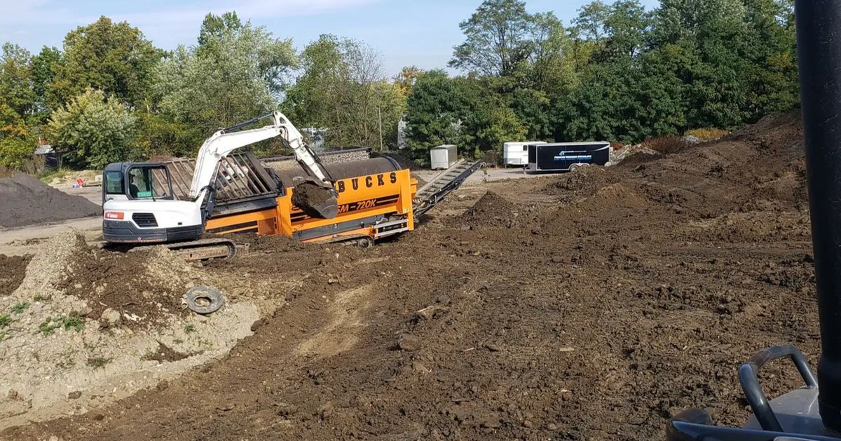 Warbucks excavator and screening equipment working on a Salem-area excavation site